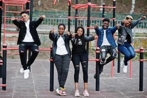 Young millennials african friends on outdoor gym. Happy black people having fun together. Generation Z friendship concept. photo