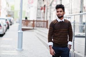 Portrait of young stylish indian man model pose in street. photo