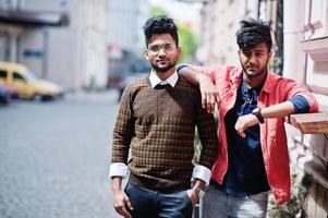 Two young stylish indian man frieds model posing in street. photo