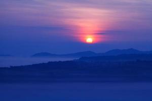 Misty morning sunrise in Khao Takhian Ngo View Point at Khao-kho Phetchabun,Thailand photo