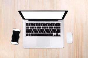 Top view laptop computer with mobile phone on wood table.Business template mock up for adding your text. photo