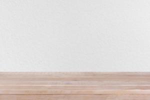 brown wood table top on white concrete wall background - can be used for montage or display your products photo