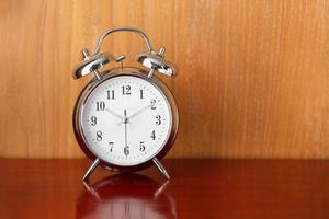 alarm table clock on wood table photo