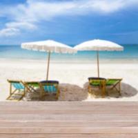 Wood table top on blurred blue sea and white sand beach background photo