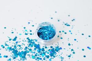 Glitter for nails and body.Beautiful glitter for nails and body close-up. Blue glitter on gray background photo