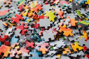 Multicolored puzzles. Family game. Concept of putting together disconnected elements.Puzzle background photo