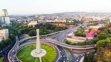 Tbilisi, Georgia, 2022 - static view automobiles in traffic on roundabout in Tbilisi center. Square of heroes monument photo