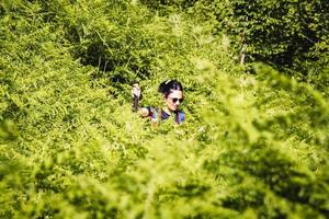 Young female hiker solo hike get lost in high grass after wrong turn in wilderness angry and upset out of desperation photo