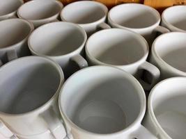 the arrangement of ceramic glasses neatly lined up on a shelf photo