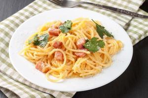 Pasta Carbonara served on a white plate. photo