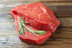 Fresh raw meat with rosemary photo