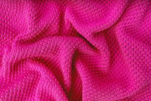 Bright pink knitwear wool fabric texture background. Abstract textile backdrop photo