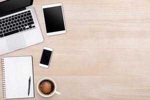 Top view laptop computer or notebook,mobile phone and cup of latte art coffee on wooden table. Business template mock up for adding your text. photo