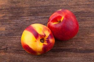 nectarines on wooden table photo