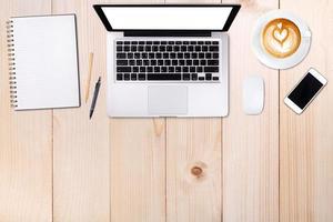 Top view laptop computer or notebook,mobile phone and cup of latte art coffee on wooden table. Business template mock up for adding your text. photo