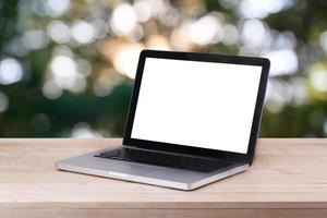 Front view of the laptop is on the work table and bokeh background photo