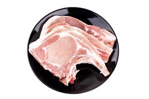 Raw pork chop on plate broad or cooking pork chop steak photo