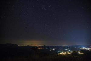 Geminid Meteor in the night sky over Wat Phra That Pha Son Kaew temple, Phetchabun Thailand photo
