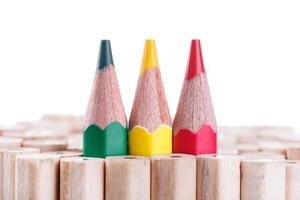 three sharpened green,yellow,red pencil among many ones photo