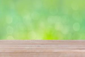 Wood table top on bokeh green background photo