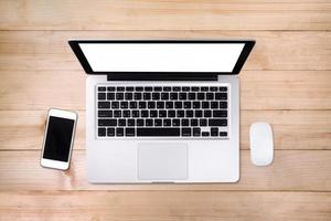 Top view laptop computer with mobile phone on wood table.Business template mock up for adding your text. photo