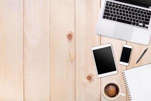 Top view laptop computer or notebook,mobile phone and cup of latte art coffee on wooden table. Business template mock up for adding your text. photo