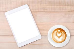 Latte coffee and Mobile phone or tablet with blank screen mockup wood background photo