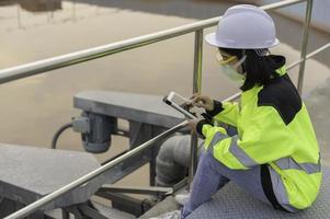 Environmental engineers work at wastewater treatment plants,Water supply engineering working at Water recycling plant for reuse photo