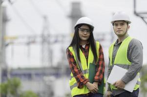 Two engineer working at power plant,Work together happily,Help each other analyze the problem,Consult about development guidelines photo
