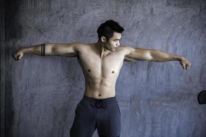 Portrait of asian man big muscle at the gym,Thailand people,Workout for good healthy,Body weight training,Fitness at the gym concept photo