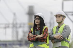 Two engineer working at power plant,Work together happily,Help each other analyze the problem,Consult about development guidelines photo