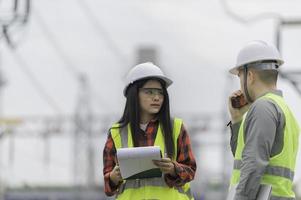 Two engineer working at power plant,Work together happily,Help each other analyze the problem,Consult about development guidelines photo