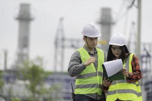 Two engineer working at power plant,Work together happily,Help each other analyze the problem,Consult about development guidelines photo
