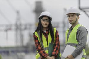Two engineer working at power plant,Work together happily,Help each other analyze the problem,Consult about development guidelines photo