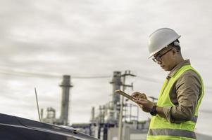 Asian man petrochemical engineer working at oil and gas refinery plant industry factory,The people worker man engineer work control at power plant energy industry manufacturing photo