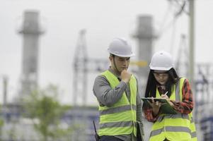 Two engineer working at power plant,Work together happily,Help each other analyze the problem,Consult about development guidelines photo