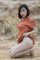 Portrait of beautiful asian sexy woman in Cheongsam dress,Thailand people,Happy Chinese new year concept photo