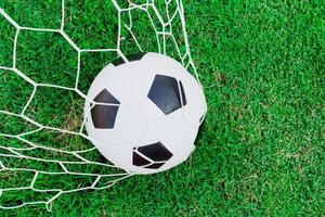 Soccer ball on goal with net photo