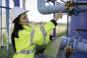 Environmental engineers work at wastewater treatment plants,Female plumber technician working at water supply photo