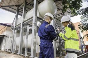 Engineers work place to keep liquid helium,preventive maintenance schedule checking,Thailand people,Technicians and engineers discuss work together. photo