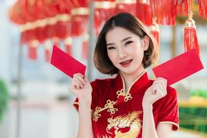 Portrait beautiful asian woman in Cheongsam dress,Thailand people,Happy Chinese new year concept,Happy  asian lady in chinese traditional dress photo