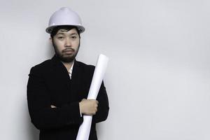 Handsome asian Engineer man Wear a suit,Wearing a helmet on white background,Thailand people photo