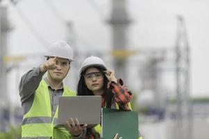 Two engineer working at power plant,Work together happily,Help each other analyze the problem,Consult about development guidelines photo