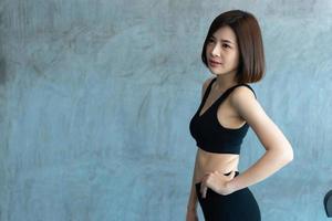 Close up asian beautiful sport girl on wall of gym,Thailand love health,Slim woman workout concept photo