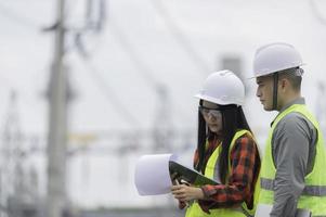 Two engineer working at power plant,Work together happily,Help each other analyze the problem,Consult about development guidelines photo