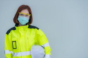 Beautiful asian Engineer woman Wear a suit, glasses and wearing a helmet on white background,Thailand people photo
