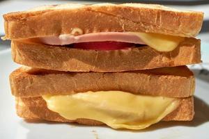 Hot sandwich with fried bread, cheese and sausage. photo