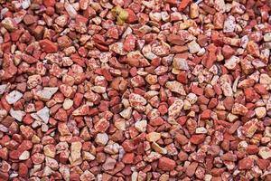 Background is made of red decorative small stones. Everything is covered with red rubble photo