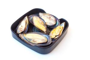 Fresh mussels were put on a black plate and served in Sukiyaki or Shabu buffet restaurant. photo