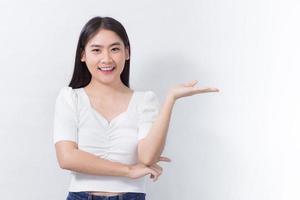 Portrait Asian woman is smiling and shows her hands to present something on the white background. photo